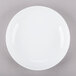 A white porcelain soup bowl with a white rim on a gray surface.