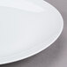 A close up of a 10 Strawberry Street Classic White Porcelain Charger Plate with a white rim.