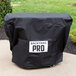 A black Backyard Pro grill cover on a table.