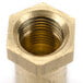 A brass threaded nut with a white background.