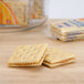 A Lance Captain's Wafers Peanut Butter & Honey Sandwich Cracker next to a box of crackers on a table.