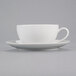 A close-up of a white 10 Strawberry Street Royal Coupe cup and saucer on a white surface.