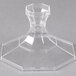 A clear glass object with a hexagon shaped base.