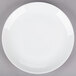 A 10 Strawberry Street Royal Coupe white porcelain plate with a white rim on a gray surface.