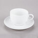 A close up of a 10 Strawberry Street white porcelain cup and saucer with a handle.