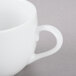 A close-up of a white cup with a saucer.