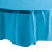 A turquoise blue plastic table cover with a white octagonal design on a table.