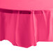 A hot magenta pink Creative Converting OctyRound table cover on a table.