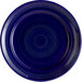 A cobalt blue Tuxton Concentrix china plate with a circular spiral pattern.