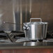 A Vollrath Arkadia pot cover on a pot on a stove.