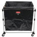A Rubbermaid laundry cart with a black bag.