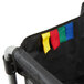 A white Rubbermaid laundry cart with a black bag and colorful flags.
