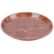 A round wooden Cambro tray with a java teak finish.