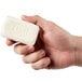 A hand holding a Dial White Marble deodorant soap bar.