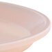 A close-up of a light peach Cambro bowl.