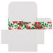 A white candy box with red and green poinsettia designs.