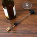A Franmara cork retriever attached to a wine bottle.