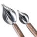 A close-up of two Zeroll stainless steel spoons with beech wood handles with a leaf design.