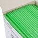 A white box of green 10" unwrapped plastic straws.