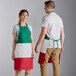 A man and woman wearing green and white Italian bib aprons with pockets.