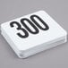 A stack of American Metalcraft plastic table number cards with black numbers 251 to 300.