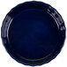A blue fluted quiche dish with a scalloped edge.