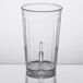 A clear plastic tumbler with a needle in it.