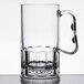 A clear SAN plastic beer mug with a handle on a table.