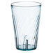 A clear plastic tumbler with a wavy design on the bottom and a blue rim.