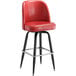 A Lancaster Table & Seating crimson vinyl bar stool with black legs.