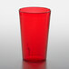 A red plastic cup on a white surface.