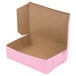 A pink bakery box with the lid open.