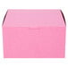 A close-up of a pink bakery box with a lid.