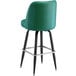 A Lancaster Table & Seating green vinyl bar stool with black legs.