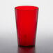 A red plastic tumbler on a white table.