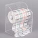 A clear plastic Noble Products dispenser with rolls of food labeling stickers on plastic holders.