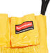A yellow Rubbermaid commercial caddy bag with black straps.