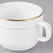 A bright white porcelain coffee cup with a gold rim.