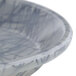 A close-up of a gray and white Cambro round fiberglass tray with a swirl design.