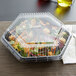 A salad in a Genpak clear plastic container with a clear hexagonal lid.