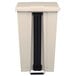 A beige rectangular Rubbermaid commercial trash can with black handle.