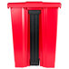 A red Rubbermaid rectangular step-on trash can with black lid and handles.