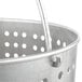 A close up of a Vollrath stainless steel fryer basket with holes in it.