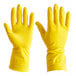 A hand wearing a yellow Cordova rubber glove.