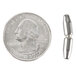 A close-up of a silver metal pin next to a silver coin.