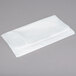 A white plastic bag on a gray surface.