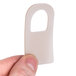 A person holding a white plastic door seal.