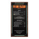A Menu Solutions dark cork menu cover on a wooden board.