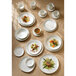 A table with Homer Laughlin Alexa Ameriwhite bright white plates and bowls on it.