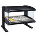 A black food warmer display case with food on a tray.